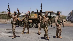 FILE PHOTO: Syrian security forces walk together along a street, after clashes between Syrian government troops and local Druze fighters resumed in the southern Druze city of Sweida early on Wednesday, collapsing a ceasefire announced just hours earlier that aimed to put an end to days of deadly sectarian bloodshed, in Sweida, Syria July 16, 2025. REUTERS/Karam al-Masri/File Photo/Karam Al-masri