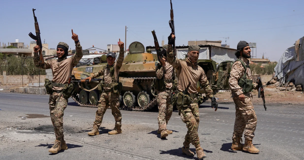 FILE PHOTO: Syrian security forces walk together along a street, after clashes between Syrian government troops and local Druze fighters resumed in the southern Druze city of Sweida early on Wednesday, collapsing a ceasefire announced just hours earlier that aimed to put an end to days of deadly sectarian bloodshed, in Sweida, Syria July 16, 2025. REUTERS/Karam al-Masri/File Photo/Karam Al-masri