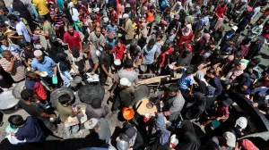 Palestinians gather to receive food from a charity kitchen, amid a hunger crisis, in Nuseirat, central Gaza Strip, July 20, 2025. REUTERS/Ramadan Abed/Ramadan Abed