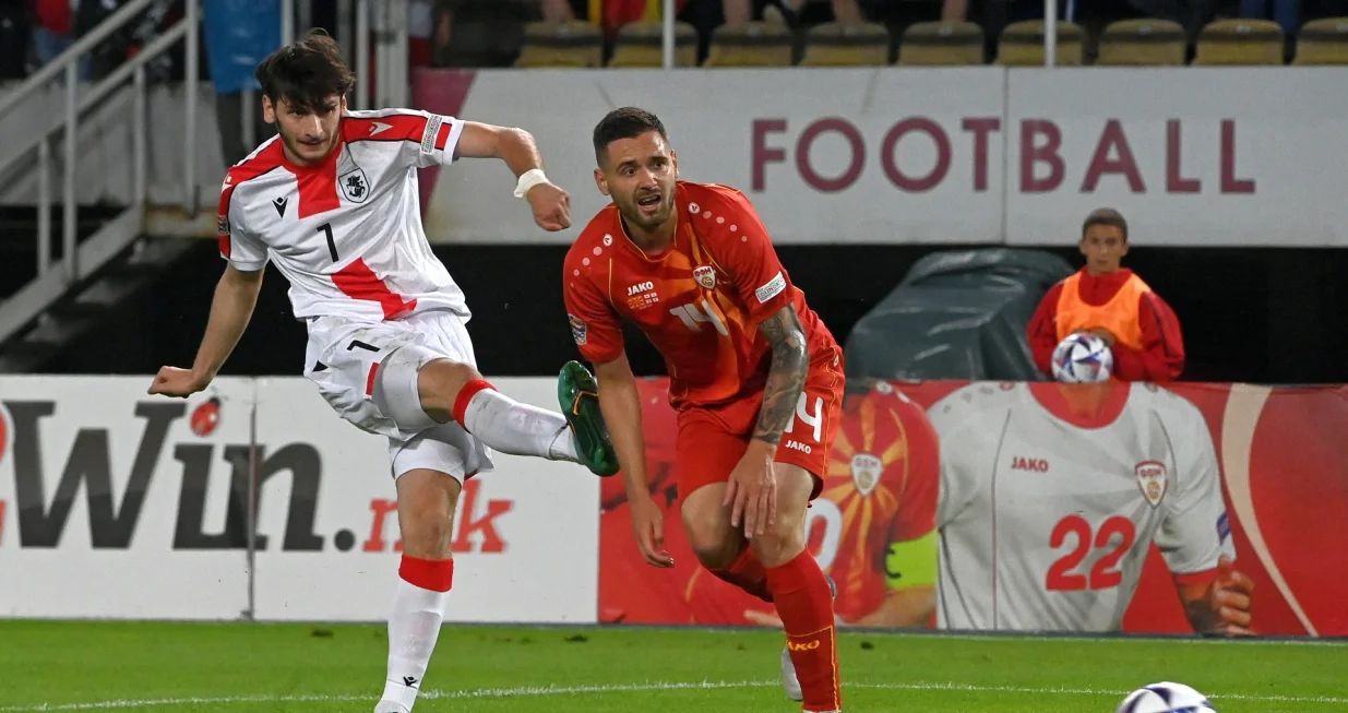 epa10004539 Georgia's Khvicha Kvaratskhelia (L) in action against North Macedonia's Darko Velkovski (R) during the UEFA Nations League soccer match between North Macedonia and Georgia in Skopje, Republic of North Macedonia, 09 June 2022. EPA/Georgi Licovski
