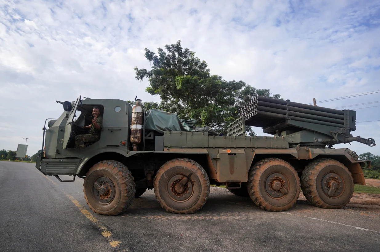 A Cambodian military personnel gestures from a BM-21 Grad multiple rocket launcher, around 40 km (24 miles) from the disputed Ta Moan Thom temple, after Thailand and Cambodia exchanged heavy artillery on Friday as their worst fighting in more than a decade stretched for a second day, in Oddar Meanchey province, Cambodia, July 25, 2025. REUTERS/Soveit Yarn/Soveit Yarn