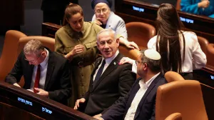 Israeli Prime Minister Benjamin Netanyahu speaks with National Security Minister Itamar Ben-Gvir, at the plenum in the Knesset, Israel's parliament, ahead of a vote over possible expulsion of Ayman Odeh from parliament, in Jerusalem, July 14, 2025. REUTERS/Ronen Zvulun/Ronen Zvulun