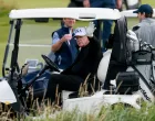 U.S. President Donald Trump waves as he sits in a golf cart at Trump Turnberry resort in Turnberry, Scotland, Britain, July 26, 2025. REUTERS/Phil Noble/Phil Noble