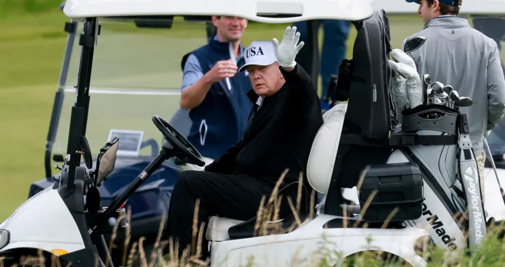 U.S. President Donald Trump waves as he sits in a golf cart at Trump Turnberry resort in Turnberry, Scotland, Britain, July 26, 2025. REUTERS/Phil Noble/Phil Noble