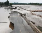 A general view of a damaged road next to the swollen Qingshui river, after a heavy rainfall flooded the area in Miyun district of Beijing, China July 28, 2025. REUTERS/Florence Lo/Florence Lo