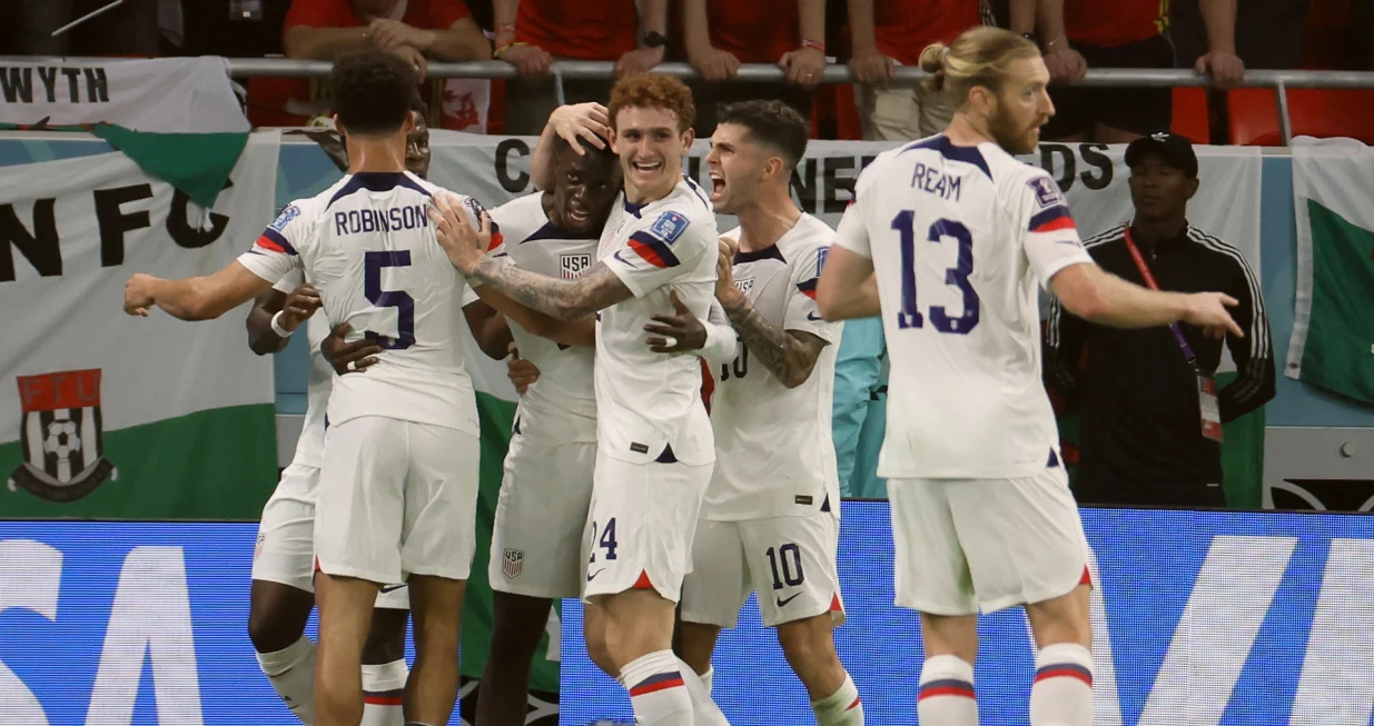 epa10318923 Timothy Weah (3L) of the USA celebrates with teammates after scoring the opening goal during the FIFA World Cup 2022 group B soccer match between the USA and Wales at Ahmad bin Ali Stadium in Doha, Qatar, 21 November 2022. EPA/Ronald Wittek