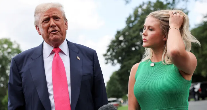 U.S. President Donald Trump speaks with reporters, while White House Press Secretary Karoline Leavitt stands next to him, as he departs for travel to Pennsylvania from the South Lawn at the White House in Washington, D.C. U.S., July 15, 2025. REUTERS/Jonathan Ernst/Jonathan Ernst