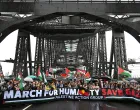 Protesters walk across the Sydney Harbour Bridge during the Palestine Action Group's March for Humanity in Sydney, Australia, August 3, 2025. AAP/Dean Lewins via REUTERS ATTENTION EDITORS - THIS IMAGE WAS PROVIDED BY A THIRD PARTY. NO RESALES. NO ARCHIVE. AUSTRALIA OUT. NEW ZEALAND OUT. NO COMMERCIAL OR EDITORIAL SALES IN NEW ZEALAND. NO COMMERCIAL OR EDITORIAL SALES IN AUSTRALIA./Dean Lewins