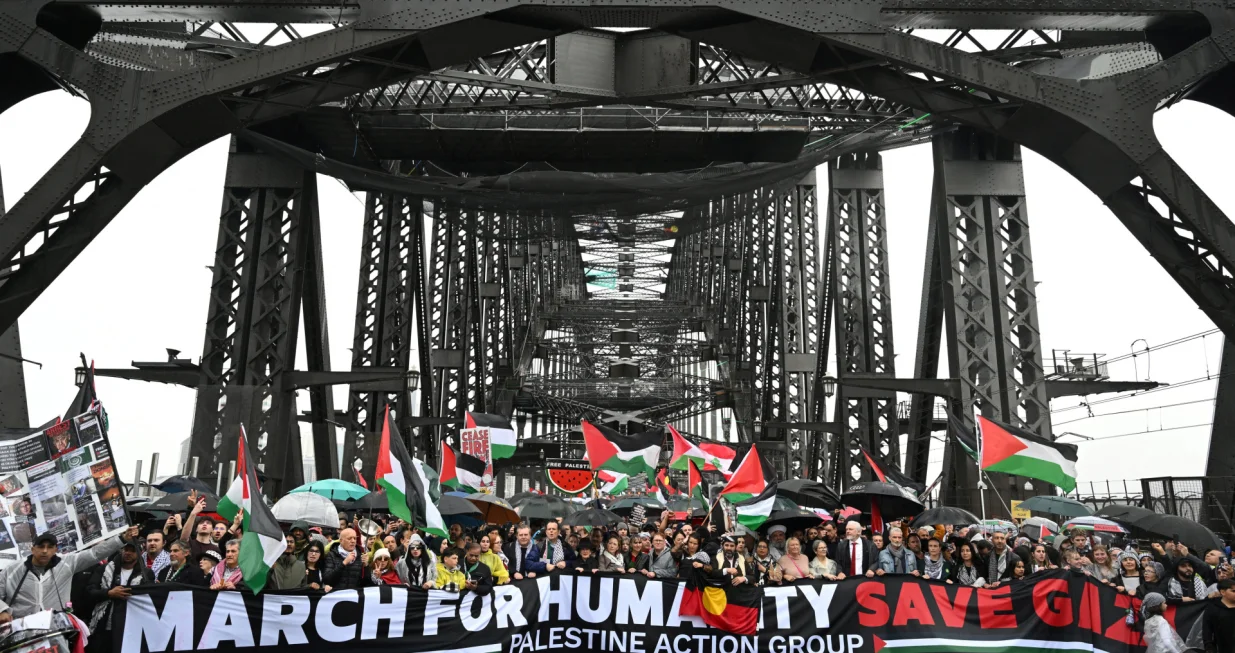 Protesters walk across the Sydney Harbour Bridge during the Palestine Action Group's March for Humanity in Sydney, Australia, August 3, 2025. AAP/Dean Lewins via REUTERS ATTENTION EDITORS - THIS IMAGE WAS PROVIDED BY A THIRD PARTY. NO RESALES. NO ARCHIVE. AUSTRALIA OUT. NEW ZEALAND OUT. NO COMMERCIAL OR EDITORIAL SALES IN NEW ZEALAND. NO COMMERCIAL OR EDITORIAL SALES IN AUSTRALIA./Dean Lewins