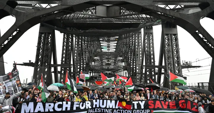 Protesters walk across the Sydney Harbour Bridge during the Palestine Action Group's March for Humanity in Sydney, Australia, August 3, 2025. AAP/Dean Lewins via REUTERS ATTENTION EDITORS - THIS IMAGE WAS PROVIDED BY A THIRD PARTY. NO RESALES. NO ARCHIVE. AUSTRALIA OUT. NEW ZEALAND OUT. NO COMMERCIAL OR EDITORIAL SALES IN NEW ZEALAND. NO COMMERCIAL OR EDITORIAL SALES IN AUSTRALIA./Dean Lewins