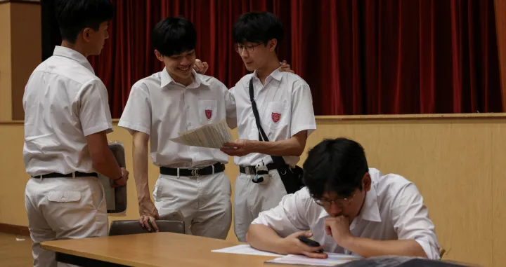 Secondary school students react after receiving their Diploma of Secondary Education (DSE) exam results in Hong Kong, China, July 16, 2025. REUTERS/Tyrone Siu/Tyrone Siu