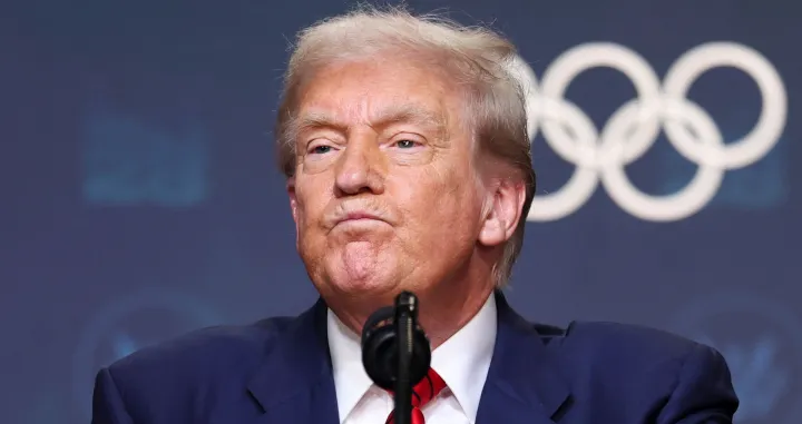 U.S. President Donald Trump reacts after signing an executive order to create a White House Olympics task force to handle security and other issues related to the LA 2028 summer Olympics in the South Court Auditorium on the White House campus in Washington, D.C., U.S., August 5, 2025. REUTERS/Jonathan Ernst/Jonathan Ernst
