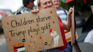 A woman holds a placard as demonstrators protest the visit of U.S. President Donald Trump, in Balmedie, near Aberdeen, Scotland, Britain, July 28, 2025. REUTERS/Hannah McKay/Hannah Mckay