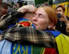 A woman reacts as she embraces her husband, a Ukrainian prisoner of war (POW) who returns after a swap, amid Russia's attack on Ukraine, in an undisclosed location in Ukraine, May 25, 2025. REUTERS/Valentyn Ogirenko  TPX IMAGES OF THE DAY/Valentyn Ogirenko