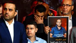 A person holds a placard with a picture of Anas Al Sharif, as Al Jazeera staff members gather at the network's studios to remember him, Mohammed Qreiqeh, Ibrahim Zaher, Mohammed Noufal and another colleague, who were killed in Gaza City by an Israeli strike, in Doha, Qatar, August 11, 2025. REUTERS/Ibraheem Abu Mustafa/Ibraheem Abu Mustafa