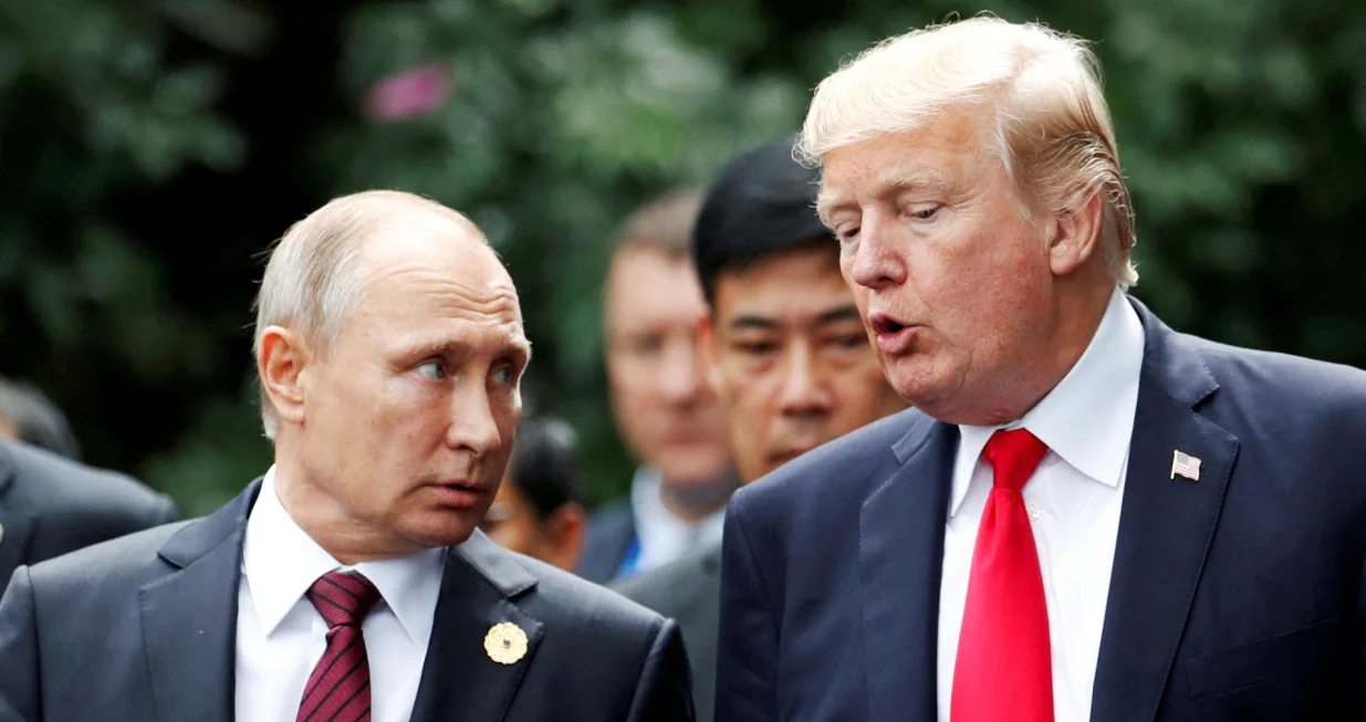 FILE PHOTO: U.S. President Donald Trump and Russia's President Vladimir Putin talk during the family photo session at the APEC Summit in Danang, Vietnam November 11, 2017. REUTERS/Jorge Silva/File Photo/Jorge Silva