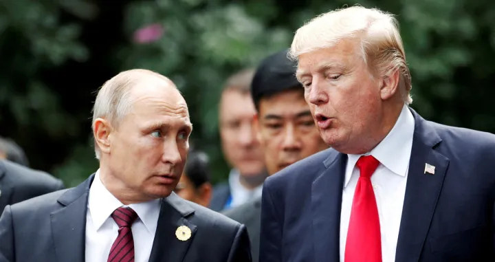 FILE PHOTO: U.S. President Donald Trump and Russia's President Vladimir Putin talk during the family photo session at the APEC Summit in Danang, Vietnam November 11, 2017. REUTERS/Jorge Silva/File Photo/Jorge Silva
