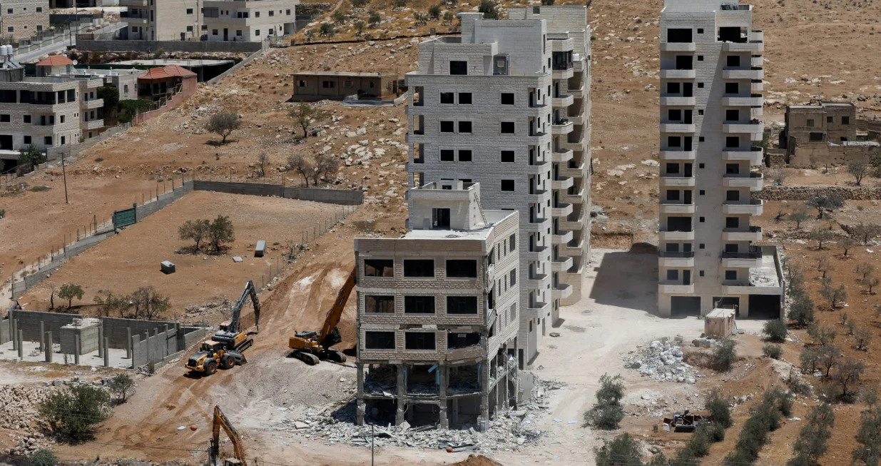 Israeli heavy machinery demolish a Palestinian building near Bethlehem in the Israeli-occupied West Bank August 6,2025. REUTERS/Mussa Qawasma/Mussa Qawasma