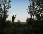A serviceman of 152nd Separate Jaeger Brigade of the Ukrainian Armed Forces checks the sky to look out for Russian combat drones, amid Russia's attack on Ukraine, near the town of Pokrovsk in Donetsk region, Ukraine August 5, 2025. REUTERS/Stringer/Stringer