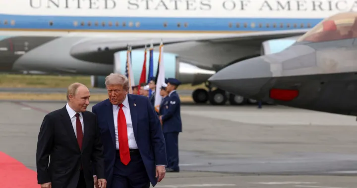 Russian President Vladimir Putin and U.S. President Donald Trump walk on the tarmac after they arrived to attend a meeting at Joint Base Elmendorf-Richardson in Anchorage, Alaska, U.S., August 15, 2025. Sputnik/Gavriil Grigorov/Pool via REUTERS ATTENTION EDITORS - THIS IMAGE WAS PROVIDED BY A THIRD PARTY./Gavriil Grigorov