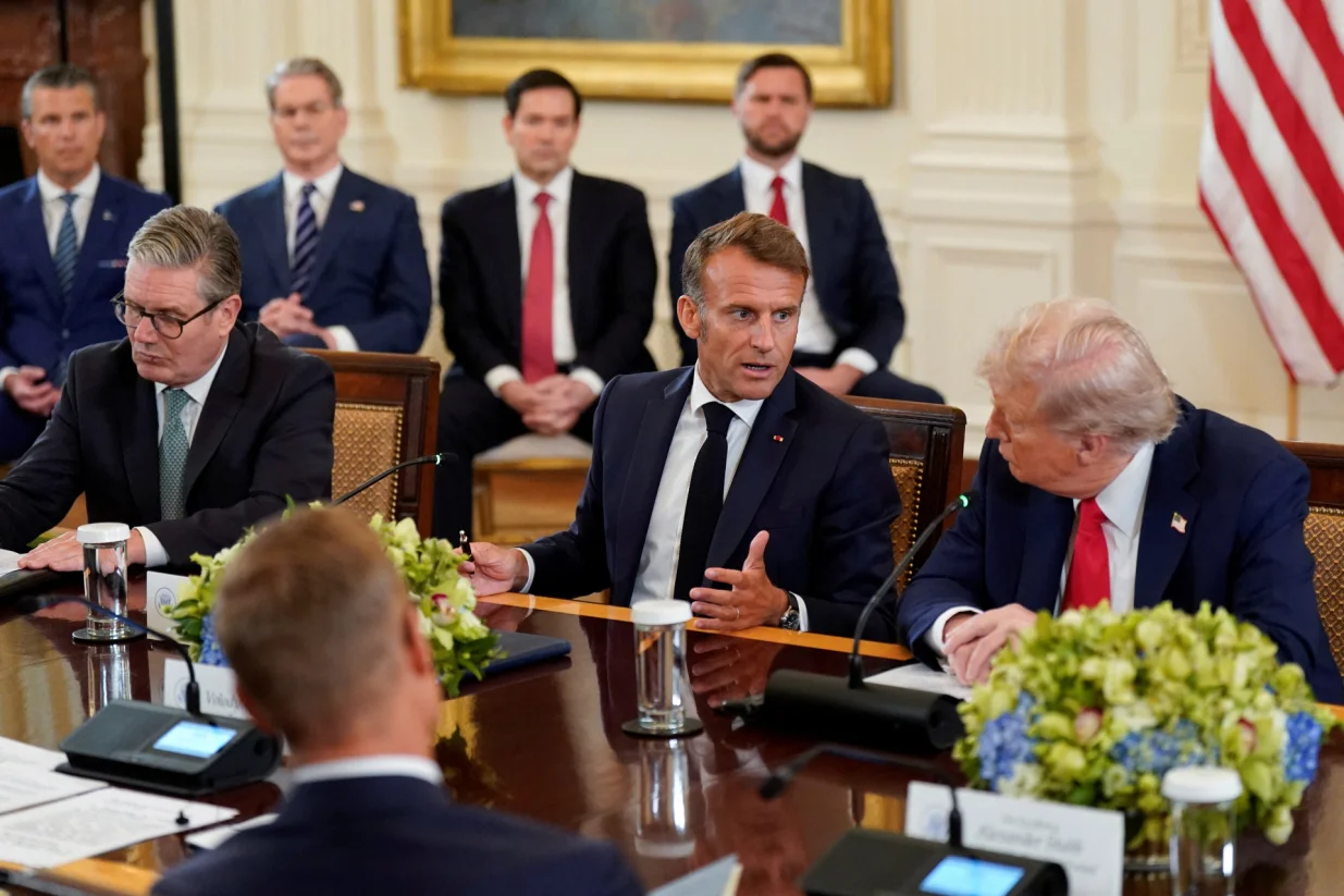 U.S. President Donald Trump and French President Emmanuel Macron speak during a meeting with Ukrainian President Volodymyr Zelenskiy (not pictured) and European leaders amid negotiations to end the Russian war in Ukraine, at the White House in Washington, D.C., U.S., August 18, 2025. REUTERS/Alexander Drago/Alexander Drago