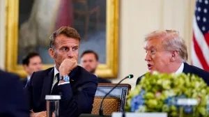 French President Emmanuel Macron speaks to U.S. President Donald Trump during a meeting with Ukrainian President Volodymyr Zelenskiy (not pictured) and European leaders amid negotiations to end the Russian war in Ukraine, at the White House in Washington, D.C., U.S., August 18, 2025. REUTERS/Al Drago/Alexander Drago