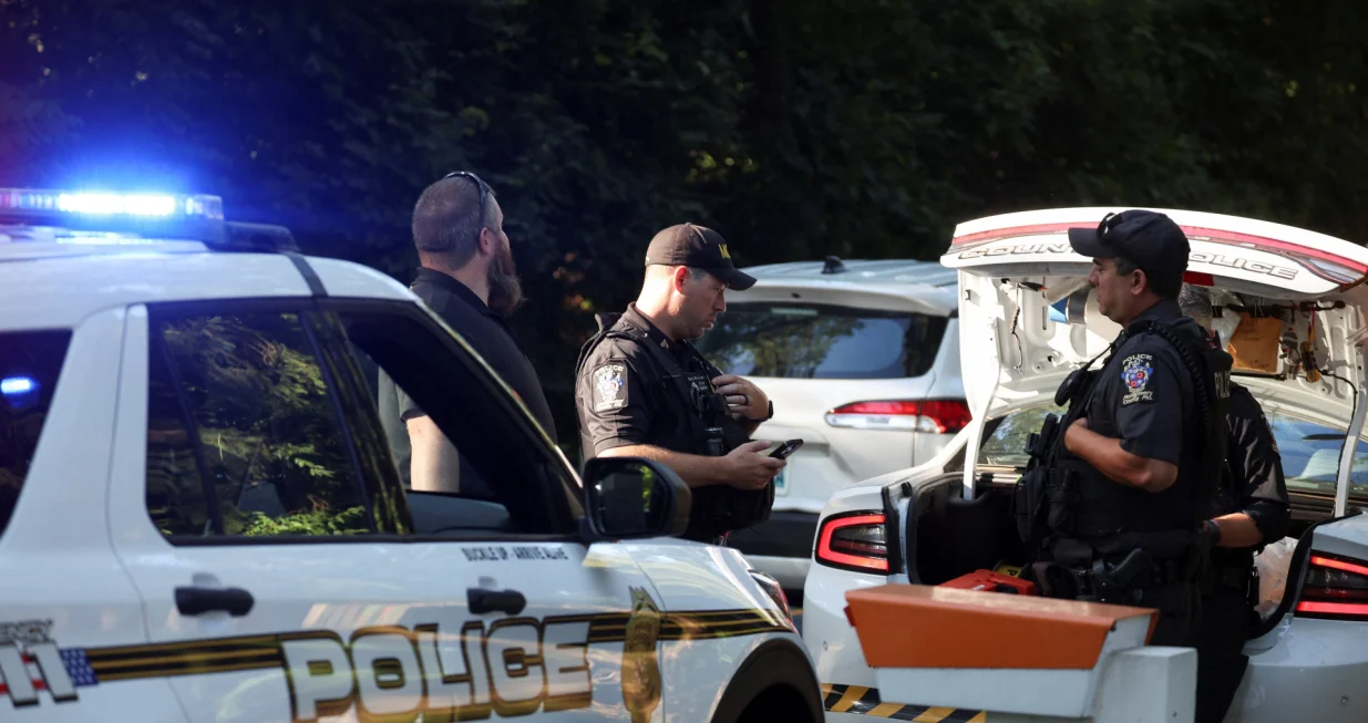 Police officers stand outside the home of the former White House national security adviser John Bolton as it is searched by FBI members, in Bethesda, Maryland, U.S., August 22, 2025. REUTERS/Tasos Katopodis/Tasos Katopodis
