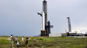 FILE PHOTO: Rocket fans walk in the sand dunes as they look over the SpaceX Starship spacecraft before it?s connected to a heavy booster at the launch pad at the company's complex in Starbase, Texas, U.S., August 23, 2025. REUTERS/Steve Nesius/File Photo/Steve Nesius