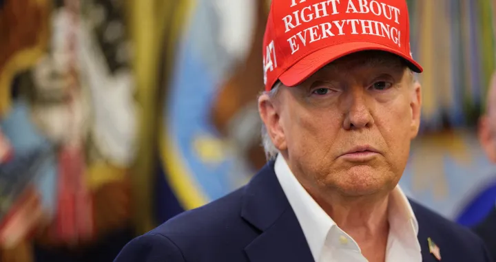 U.S. President Donald Trump wears a 'Trump Was Right About Everything!' hat, as he makes an announcement on the 2026 FIFA World Cup, in the Oval Office at the White House in Washington, D.C., U.S., August 22, 2025. REUTERS/Jonathan Ernst/Jonathan Ernst