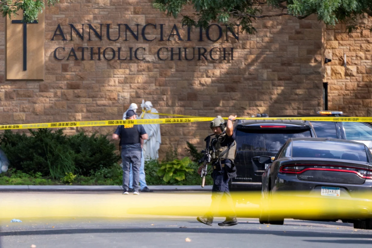 Law enforcement officers set up barriers after a shooting at Annunciation Church, which is also home to an elementary school, in Minneapolis, Minnesota, U.S. August 27, 2025. REUTERS/Ben Brewer/Ben Brewer