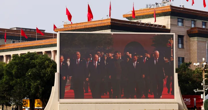 A screen shows Chinese President Xi Jinping, Russian President Vladimir Putin and North Korean leader Kim Jong Un arriving for a military parade to mark the 80th anniversary of the end of World War Two, in Beijing, China, September 3, 2025. REUTERS/Tingshu Wang REFILE - QUALITY REPEAT/Tingshu Wang