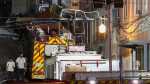 First responders walk at the site of an accident involving Lisbon's Gloria funicular, a popular tourist attraction, which derailed and crashed, resulting in fatalities and injuries, according to authorities, in Lisbon, Portugal, September 3, 2025. REUTERS/Pedro Rocha/Pedro Rocha