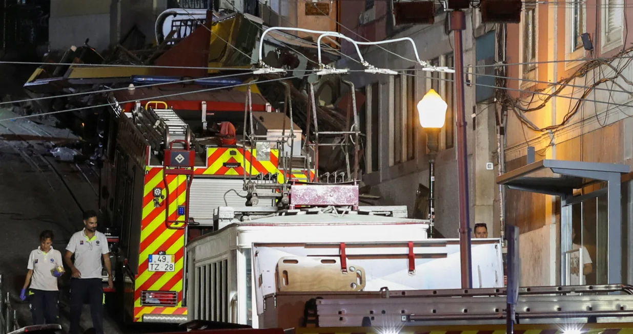 First responders walk at the site of an accident involving Lisbon's Gloria funicular, a popular tourist attraction, which derailed and crashed, resulting in fatalities and injuries, according to authorities, in Lisbon, Portugal, September 3, 2025. REUTERS/Pedro Rocha/Pedro Rocha