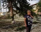A resident stands at the site of a Russian air strike which killed several civilians at a pension disbursal point, officials said on Tuesday, amid Russia's attack on Ukraine, in the village of Yarova in Donetsk region, Ukraine September 9, 2025. REUTERS/Stringer/Stringer