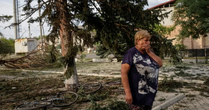 A resident stands at the site of a Russian air strike which killed several civilians at a pension disbursal point, officials said on Tuesday, amid Russia's attack on Ukraine, in the village of Yarova in Donetsk region, Ukraine September 9, 2025. REUTERS/Stringer/Stringer
