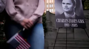 A person holds a U.S. flag as people gather during a vigil for U.S. right-wing activist and commentator Charlie Kirk, who was fatally shot while speaking at an outdoor event at Utah Valley University, at Madison Square Park in New York City, U.S., September 12, 2025. REUTERS/Adam Gray/Adam Gray