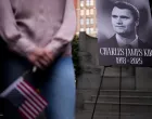 A person holds a U.S. flag as people gather during a vigil for U.S. right-wing activist and commentator Charlie Kirk, who was fatally shot while speaking at an outdoor event at Utah Valley University, at Madison Square Park in New York City, U.S., September 12, 2025. REUTERS/Adam Gray/Adam Gray