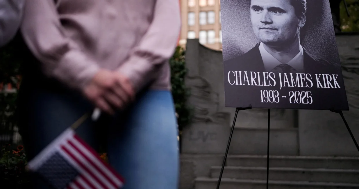 A person holds a U.S. flag as people gather during a vigil for U.S. right-wing activist and commentator Charlie Kirk, who was fatally shot while speaking at an outdoor event at Utah Valley University, at Madison Square Park in New York City, U.S., September 12, 2025. REUTERS/Adam Gray/Adam Gray