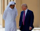 FILE PHOTO: U.S. President Donald Trump talks with Qatar's Emir Tamim bin Hamad Al Thani in Doha, Qatar, May 15, 2025. REUTERS/Brian Snyder/File Photo/Brian Snyder