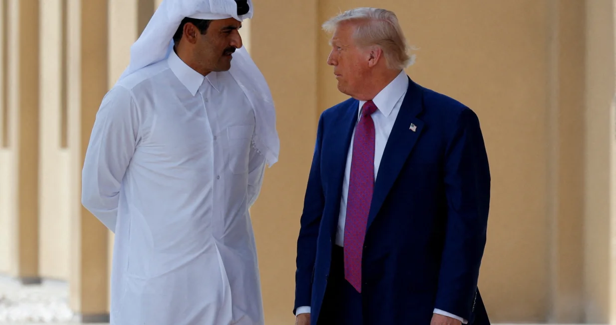FILE PHOTO: U.S. President Donald Trump talks with Qatar's Emir Tamim bin Hamad Al Thani in Doha, Qatar, May 15, 2025. REUTERS/Brian Snyder/File Photo/Brian Snyder
