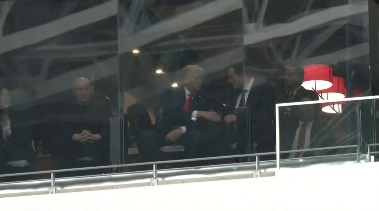 A still image from video shows U.S. President Donald Trump and Tesla CEO Elon Musk shaking hands in a skybox at State Farm Stadium during the memorial service for slain conservative commentator Charlie Kirk, in Glendale, Arizona, U.S., September 21, 2025. Reuters TV via REUTERS/Reuters Tv