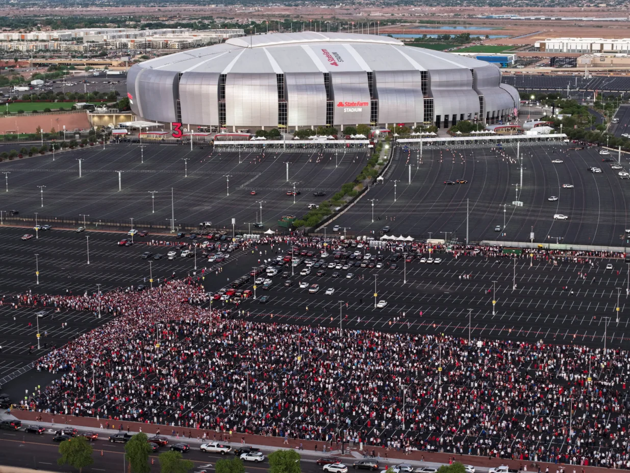 Drone view shows people arriving to attend a memorial service for slain conservative commentator Charlie Kirk at State Farm Stadium, in Glendale, Arizona, U.S., September 21, 2025. REUTERS/Cheney Orr/Cheney Orr