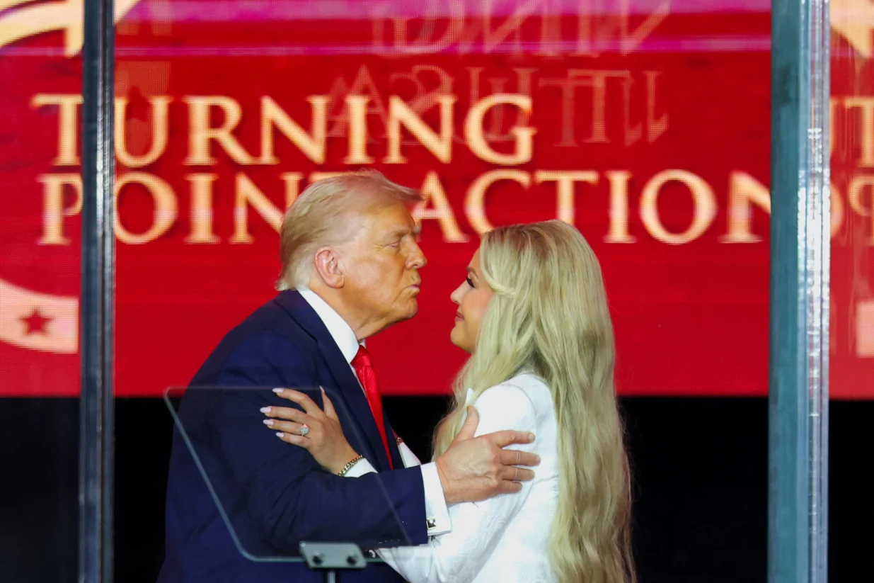 U.S. President Donald Trump leans in to kiss Erika Kirk, Charlie Kirk's widow, during a memorial service for slain conservative commentator Charlie Kirk at State Farm Stadium, in Glendale, Arizona, U.S., September 21, 2025. REUTERS/Daniel Cole/Daniel Cole