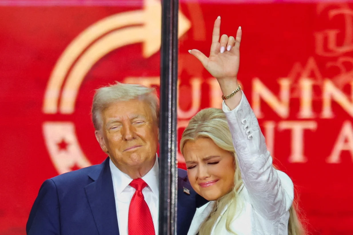 Erika Kirk, Charlie Kirk's widow, gestures next to U.S. President Donald Trump during a memorial service for slain conservative commentator Charlie Kirk at State Farm Stadium, in Glendale, Arizona, U.S., September 21, 2025. REUTERS/Daniel Cole  TPX IMAGES OF THE DAY/Daniel Cole