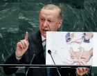 Turkey's President Tayyip Erdogan shows a picture as he addresses the 80th United Nations General Assembly at U.N. headquarters in New York, U.S., September 23, 2025. REUTERS/MIKE SEGAR/Mike Segar