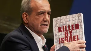 Iran's President Masoud Pezeshkian holds a book as he addresses the 80th United Nations General Assembly (UNGA) at the U.N. headquarters in New York, U.S., September 24, 2025. REUTERS/Shannon Stapleton/Shannon Stapleton