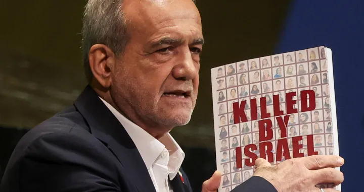 Iran's President Masoud Pezeshkian holds a book as he addresses the 80th United Nations General Assembly (UNGA) at the U.N. headquarters in New York, U.S., September 24, 2025. REUTERS/Shannon Stapleton/Shannon Stapleton