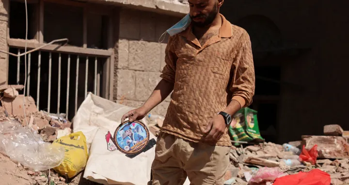 A man holds a picture of a boy as he stand at the site of a house destroyed in Wednesday&#039;s Israeli airstrikes in Sanaa, Yemen September 13, 2025. REUTERS/Khaled Abdullah/Khaled Abdullah