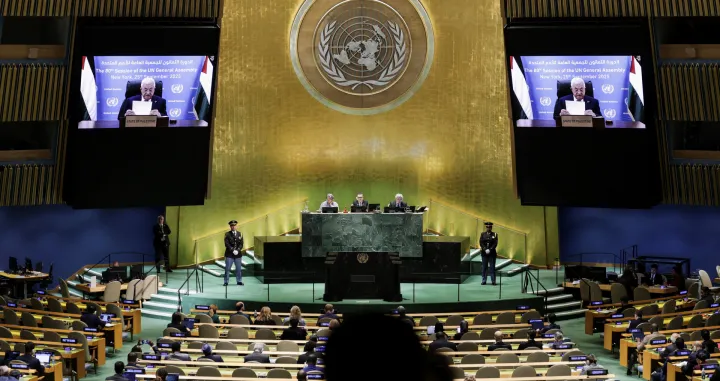 Palestinian President Mahmoud Abbas appears on screens as he addresses the 80th United Nations General Assembly (UNGA), at the U.N. headquarters in New York, U.S., September 25, 2025. REUTERS/Jeenah Moon/Jeenah Moon