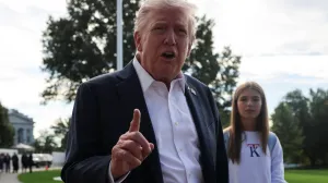 U.S. President Donald Trump speaks to the media as his granddaughter Kai Madison Trump looks on before departing for travel to New York to attend the Ryder Cup golf tournament, from the White House in Washington, D.C., U.S., September 26, 2025 REUTERS/Jonathan Ernst/Jonathan Ernst